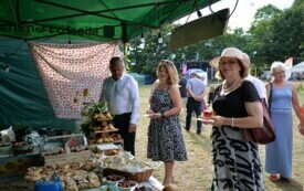 Dwie kobiety i mężczyzna stoją przy stoisku z wypiekami