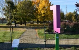 budynek z dwoma zjeżdżalniami oraz ścianką do wspinaczki w piaskownicy na unowocześnionym placu zabaw