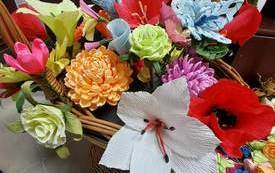na zdjęciu piękny, kolorowy bukiet kwiat&oacute;w z bibuły w wiklinowym koszyku